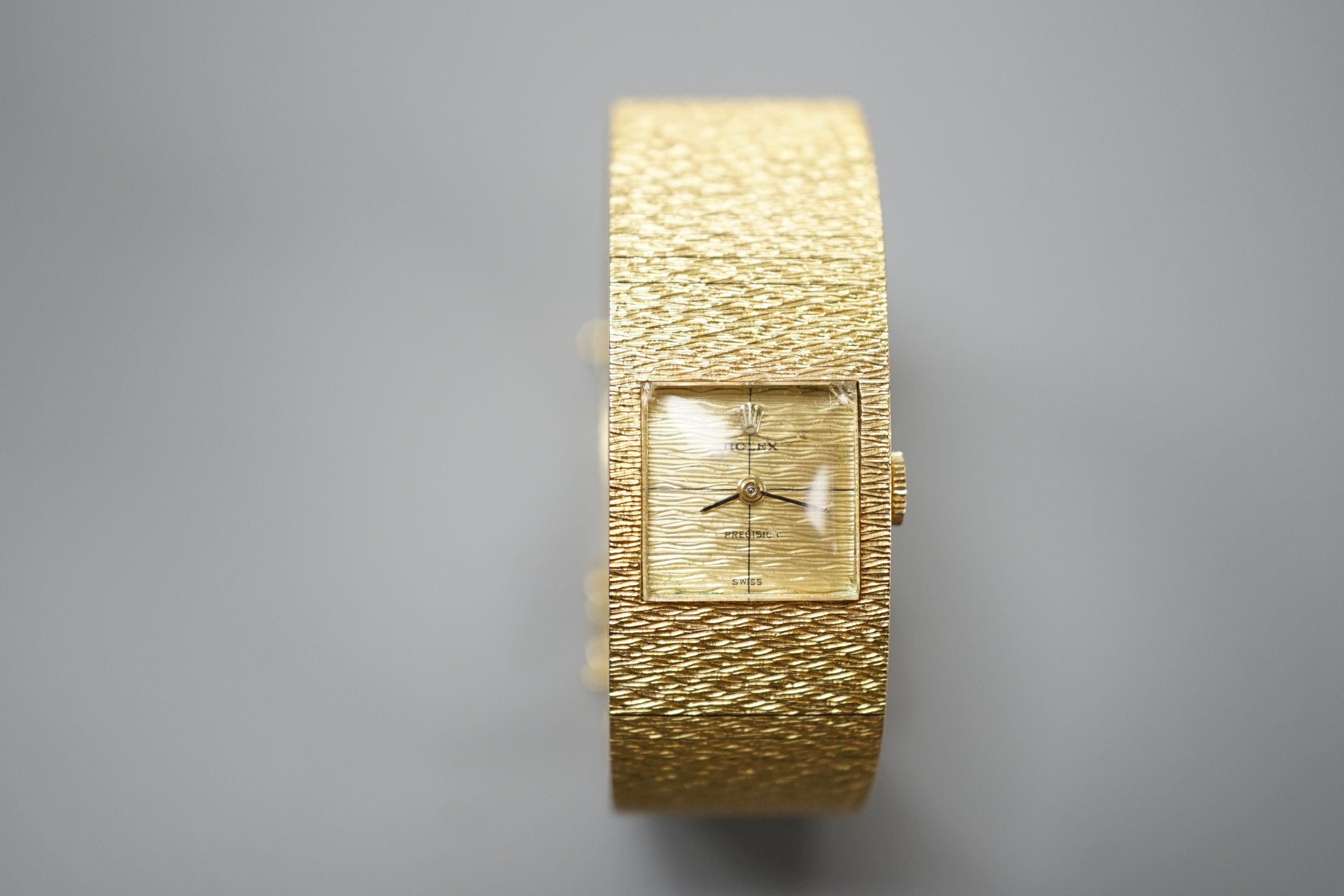 A lady's 1960's textured 18ct gold Rolex Precision manual wind bracelet watch, case diameter 17mm, gross weight 70.3 grams, with Rolex box, no papers.